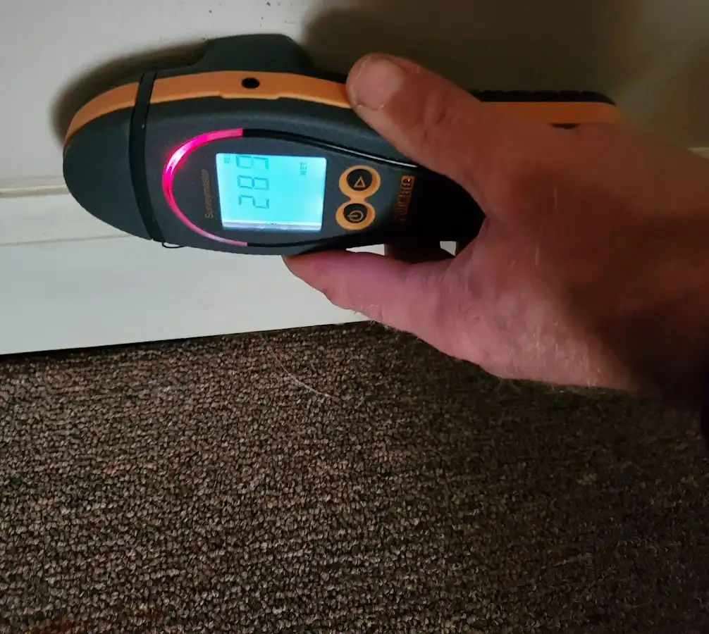Moisture detection at baseboard during Storm Damage Restoration in Hasbrouck Heights